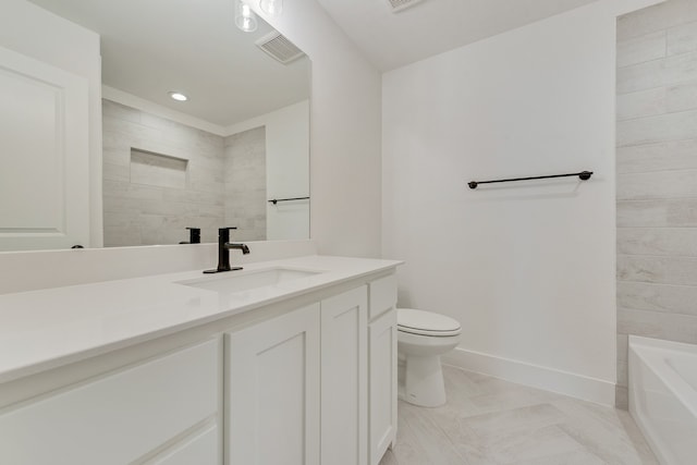 bathroom featuring vanity and toilet