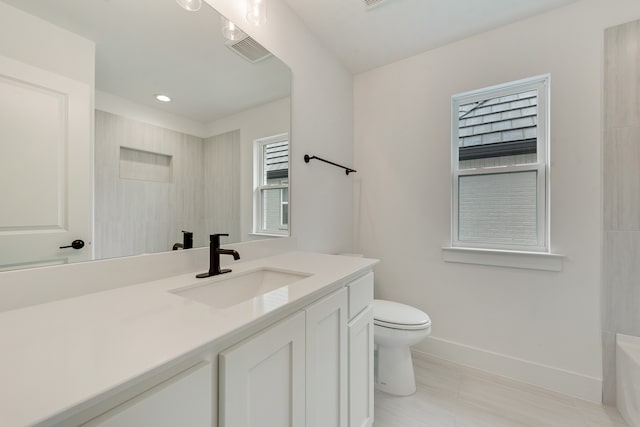 bathroom featuring vanity and toilet