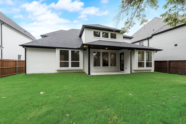 back of house featuring a yard and a patio