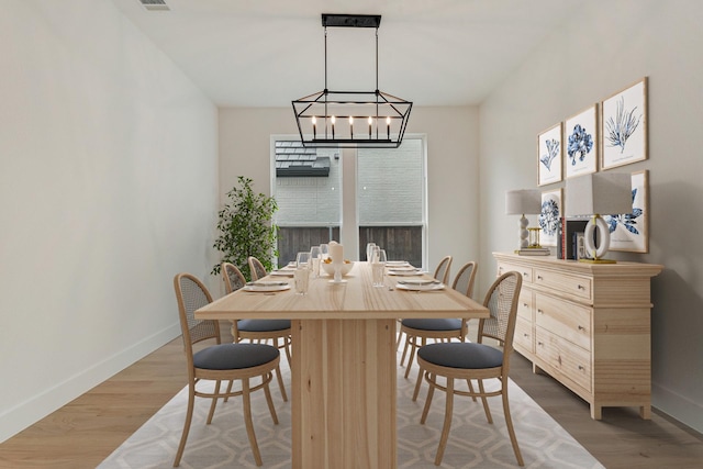 dining area featuring a notable chandelier and hardwood / wood-style flooring