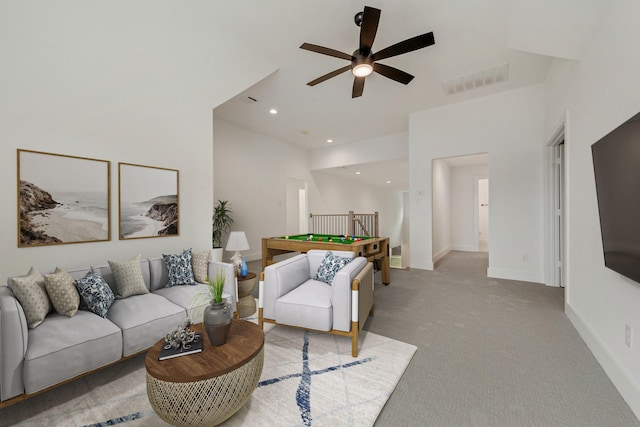 carpeted living room with ceiling fan and billiards