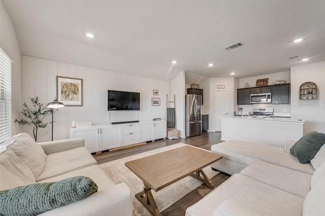 living room featuring visible vents, dark wood finished floors, and recessed lighting