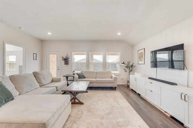 living room featuring lofted ceiling, recessed lighting, and wood finished floors