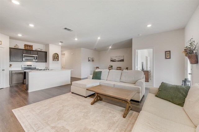 living room with hardwood / wood-style flooring and lofted ceiling