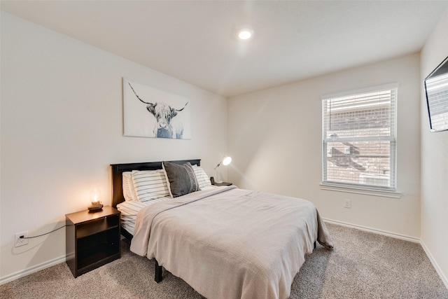 bedroom featuring light colored carpet and baseboards