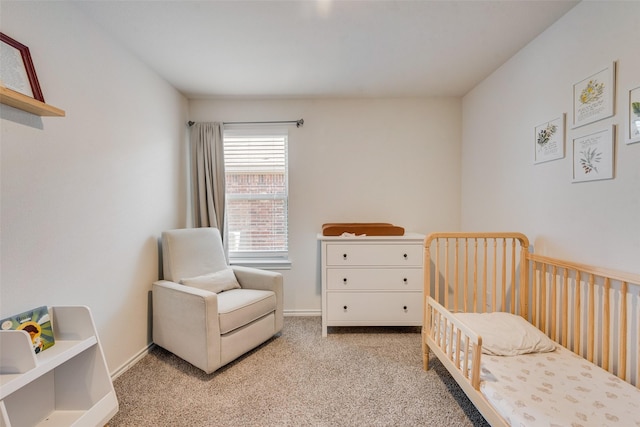 bedroom featuring light carpet and baseboards