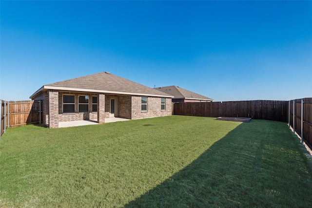 rear view of house featuring a patio and a lawn