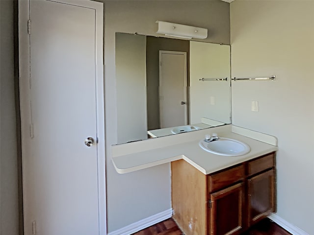 bathroom with hardwood / wood-style flooring and vanity