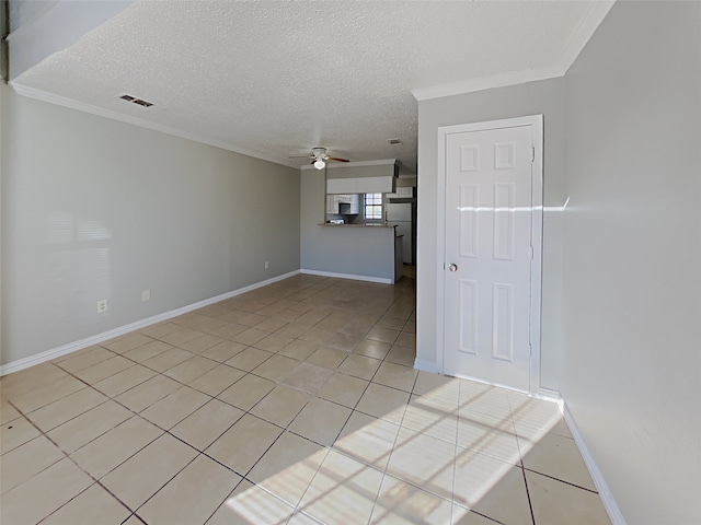 unfurnished living room featuring ceiling fan, crown molding, light tile patterned floors, and a textured ceiling