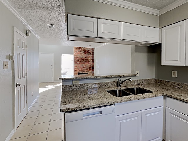 kitchen with kitchen peninsula, white dishwasher, sink, light tile patterned floors, and white cabinetry