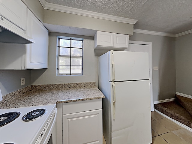 kitchen with ventilation hood, light tile patterned floors, white fridge, and white cabinetry