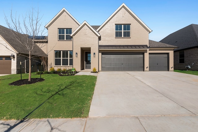 view of front of house featuring a front yard and a garage