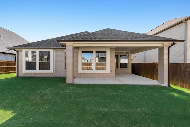 back of house with a yard and a patio