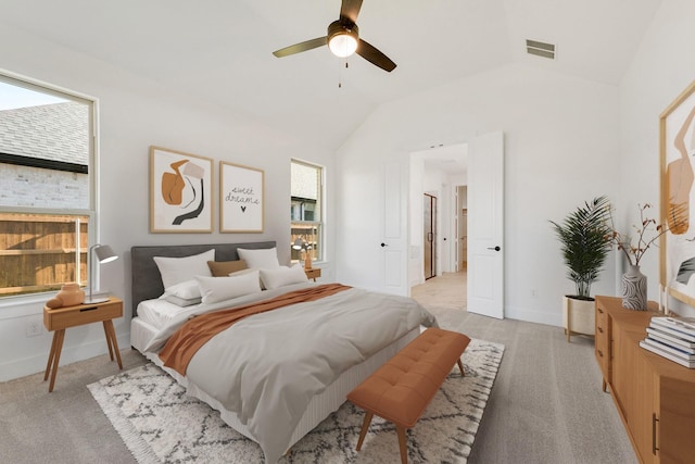 carpeted bedroom with multiple windows, vaulted ceiling, and ceiling fan