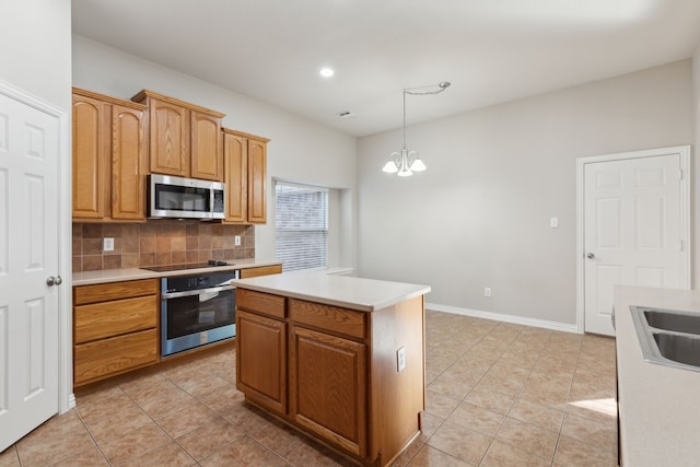 kitchen with hanging light fixtures, backsplash, a chandelier, a kitchen island, and appliances with stainless steel finishes