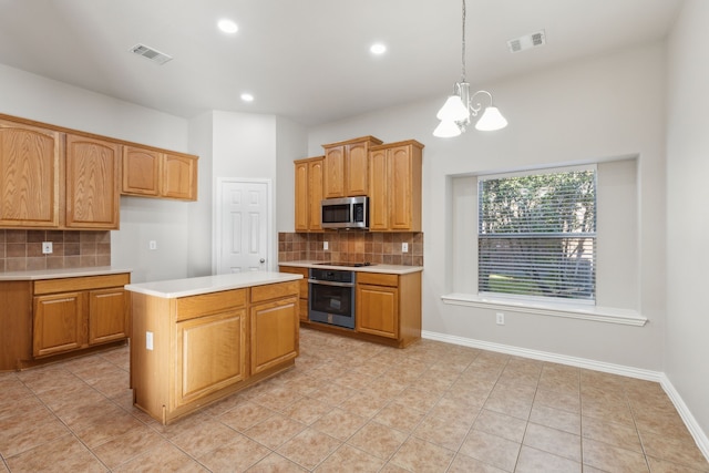 kitchen featuring a center island, hanging light fixtures, an inviting chandelier, backsplash, and appliances with stainless steel finishes