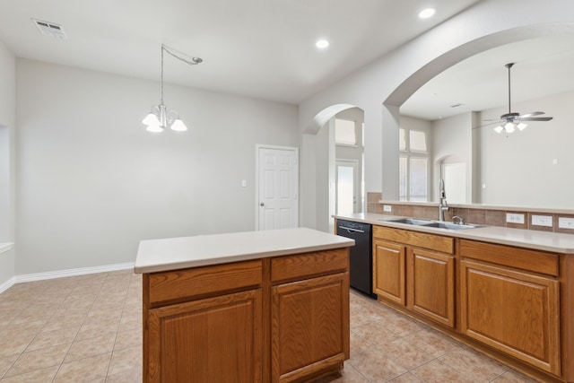 kitchen with a center island, ceiling fan with notable chandelier, sink, black dishwasher, and decorative light fixtures