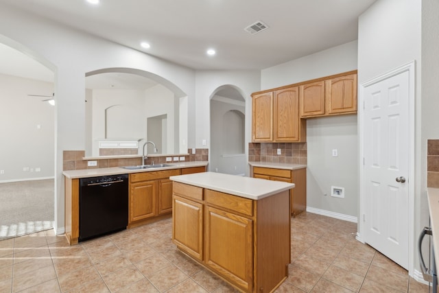 kitchen featuring ceiling fan, sink, a center island, black dishwasher, and decorative backsplash