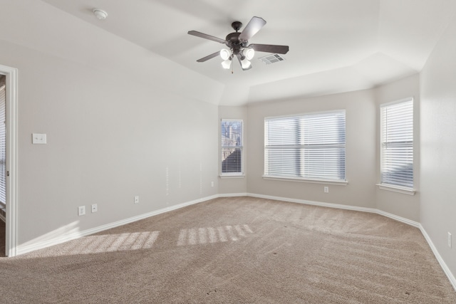 unfurnished room with a raised ceiling, ceiling fan, and carpet floors