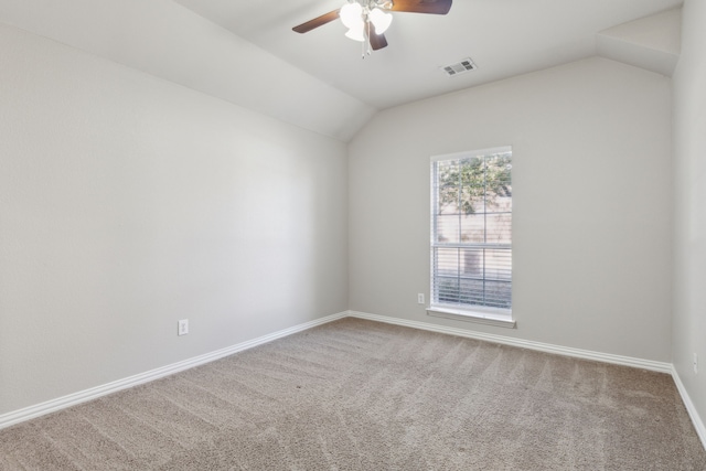 spare room featuring carpet flooring, ceiling fan, and lofted ceiling