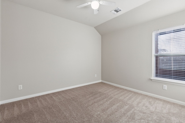 carpeted empty room featuring ceiling fan and lofted ceiling