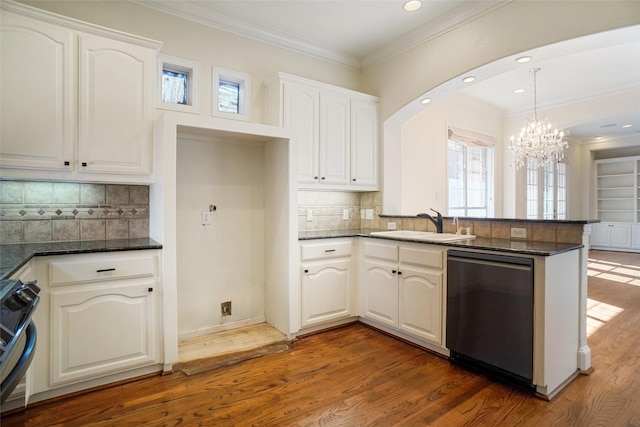 kitchen with white cabinetry, dark hardwood / wood-style floors, kitchen peninsula, decorative backsplash, and appliances with stainless steel finishes