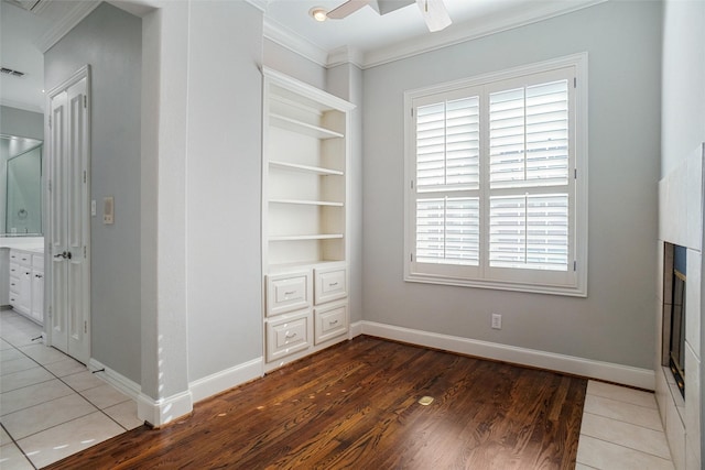 interior space with multiple windows, ceiling fan, and tile patterned flooring