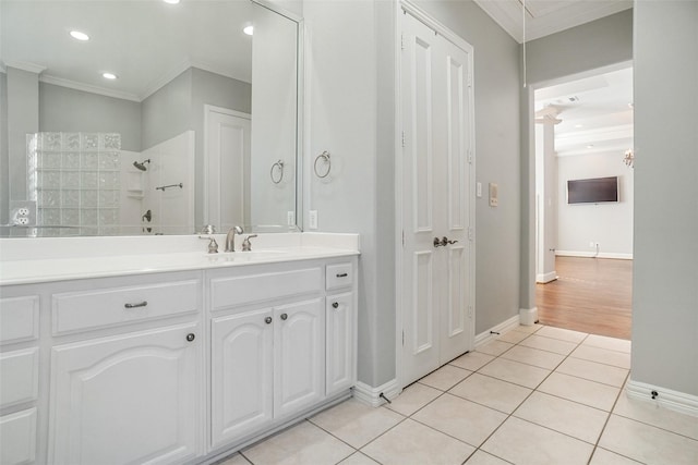 bathroom with a shower, tile patterned flooring, vanity, and crown molding