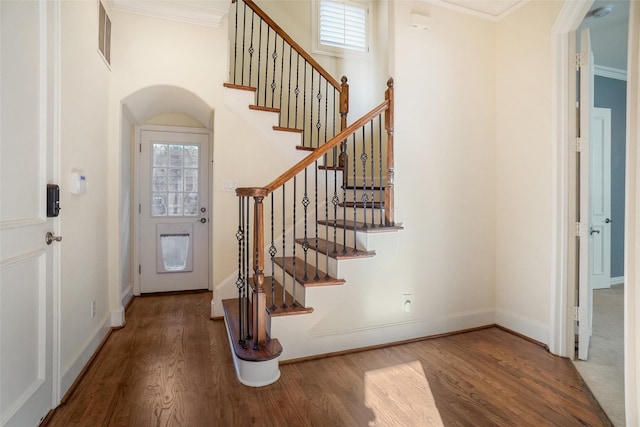 entryway featuring hardwood / wood-style floors and crown molding