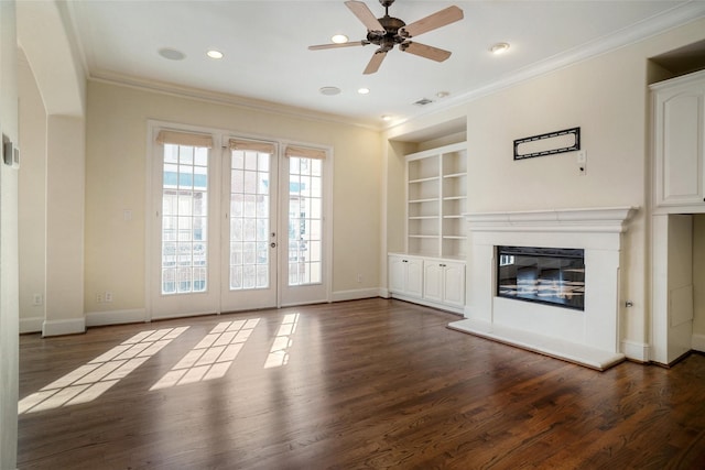 unfurnished living room featuring crown molding, ceiling fan, built in features, and wood-type flooring