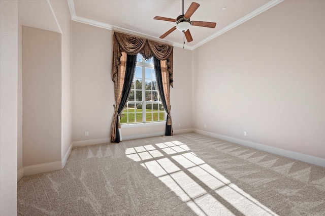 carpeted empty room featuring ceiling fan and ornamental molding