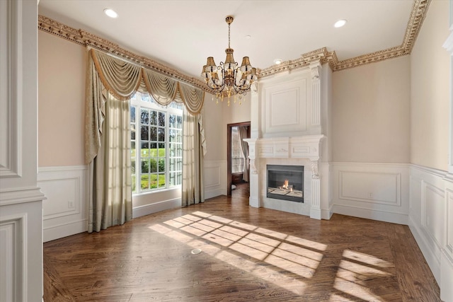 unfurnished living room with a notable chandelier and dark hardwood / wood-style floors