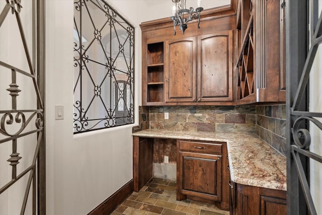 kitchen featuring tasteful backsplash and light stone counters