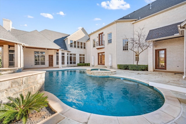 view of pool featuring an in ground hot tub