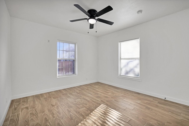 spare room with light hardwood / wood-style flooring and ceiling fan