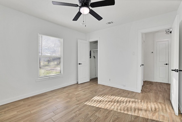 unfurnished bedroom with ceiling fan and light wood-type flooring