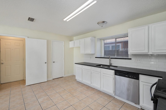 kitchen with white cabinetry, dishwasher, sink, a textured ceiling, and light tile patterned flooring