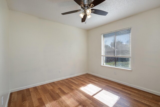 empty room with hardwood / wood-style floors, a textured ceiling, and ceiling fan