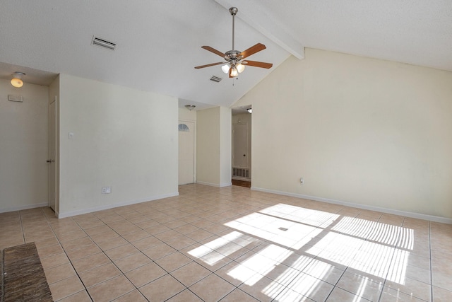 tiled empty room with a textured ceiling, lofted ceiling with beams, and ceiling fan