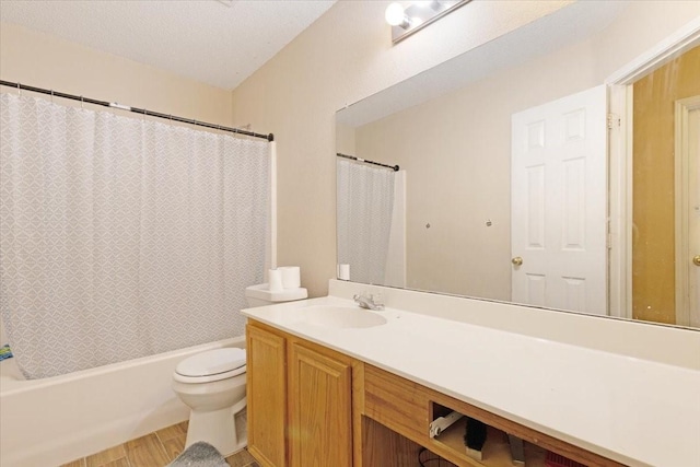 full bathroom featuring hardwood / wood-style floors, a textured ceiling, toilet, shower / tub combo with curtain, and vanity