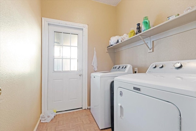 laundry area with independent washer and dryer and light parquet flooring