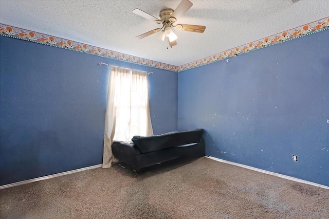 unfurnished room with carpet, ceiling fan, and a textured ceiling