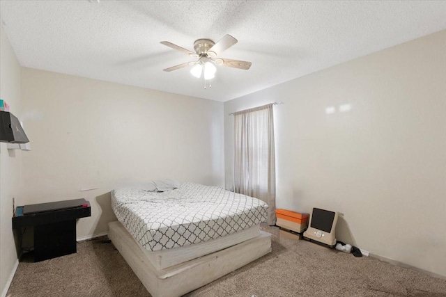 bedroom with ceiling fan, carpet, and a textured ceiling