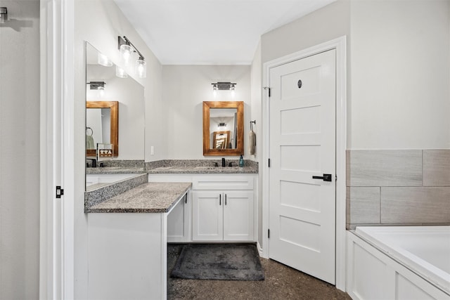 bathroom with a bath and vanity