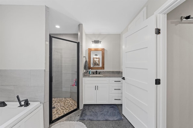 bathroom with vanity and independent shower and bath