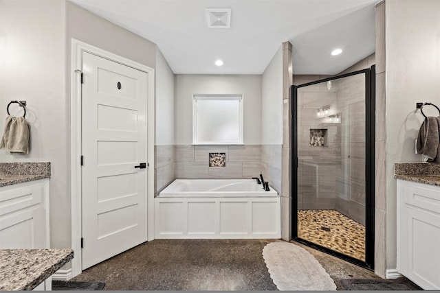 bathroom featuring vanity and shower with separate bathtub