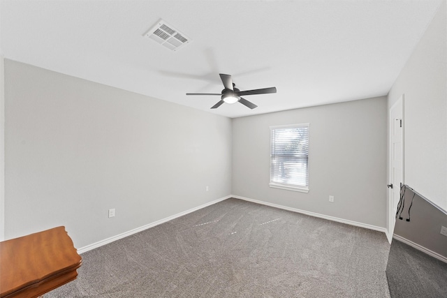 carpeted spare room with ceiling fan