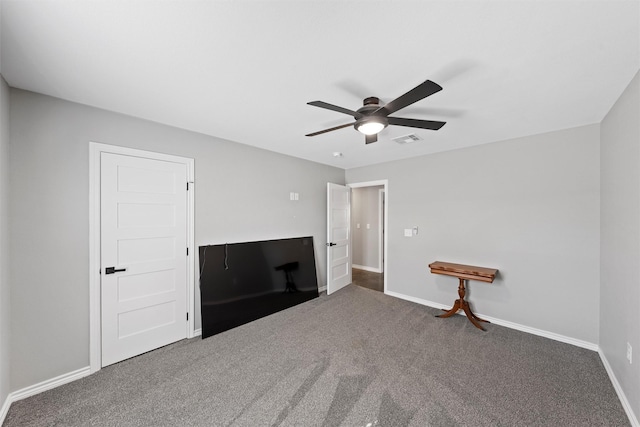 unfurnished bedroom featuring dark colored carpet and ceiling fan