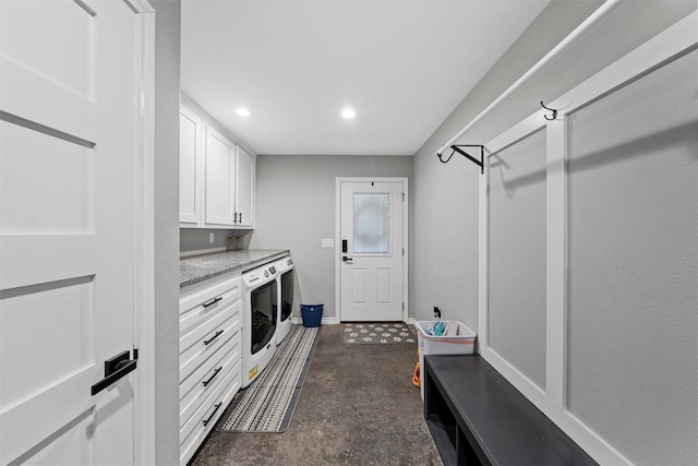 laundry room with cabinets and washing machine and clothes dryer