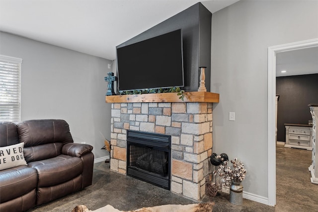 living room with a stone fireplace